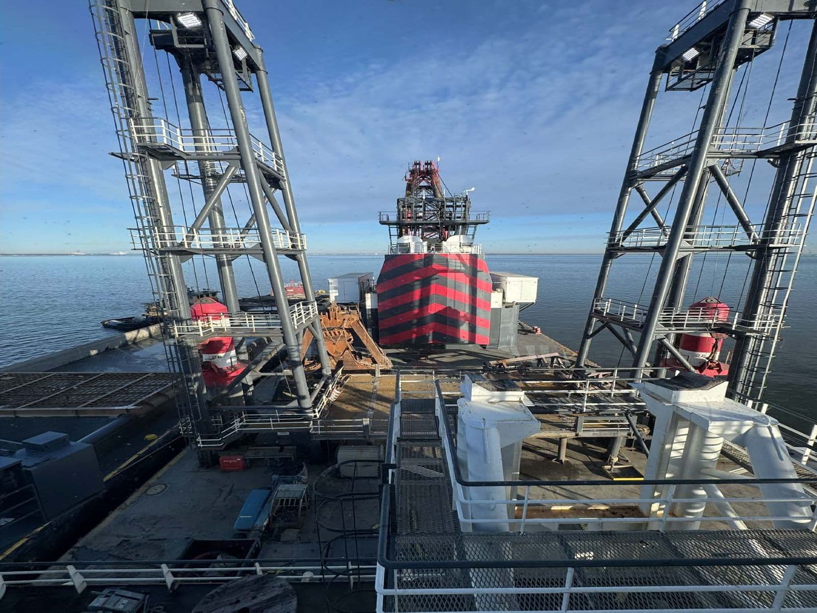 Dredging spud barge with crane housing working on open water
